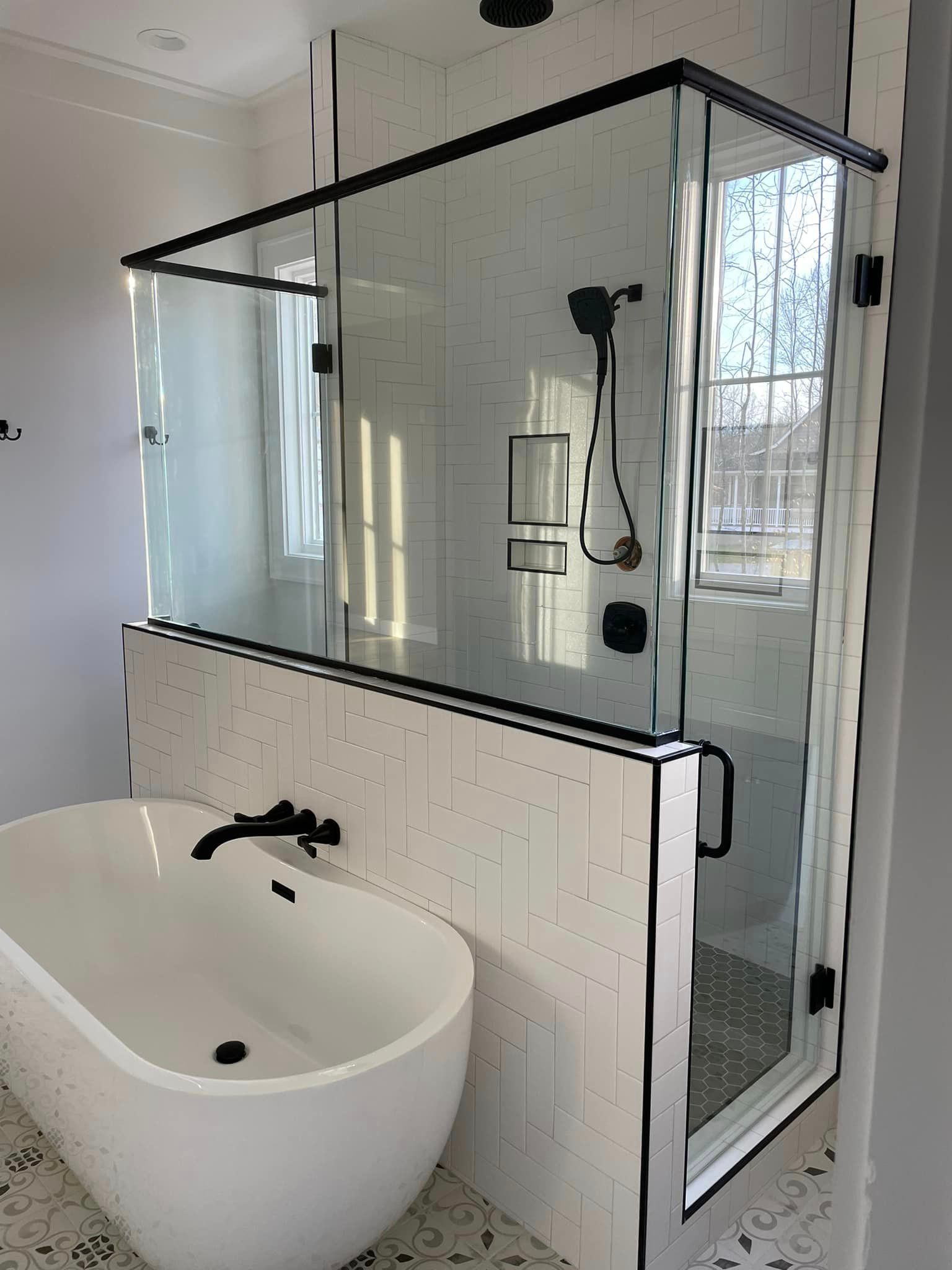 A bathroom with a bathtub and a walk in shower.