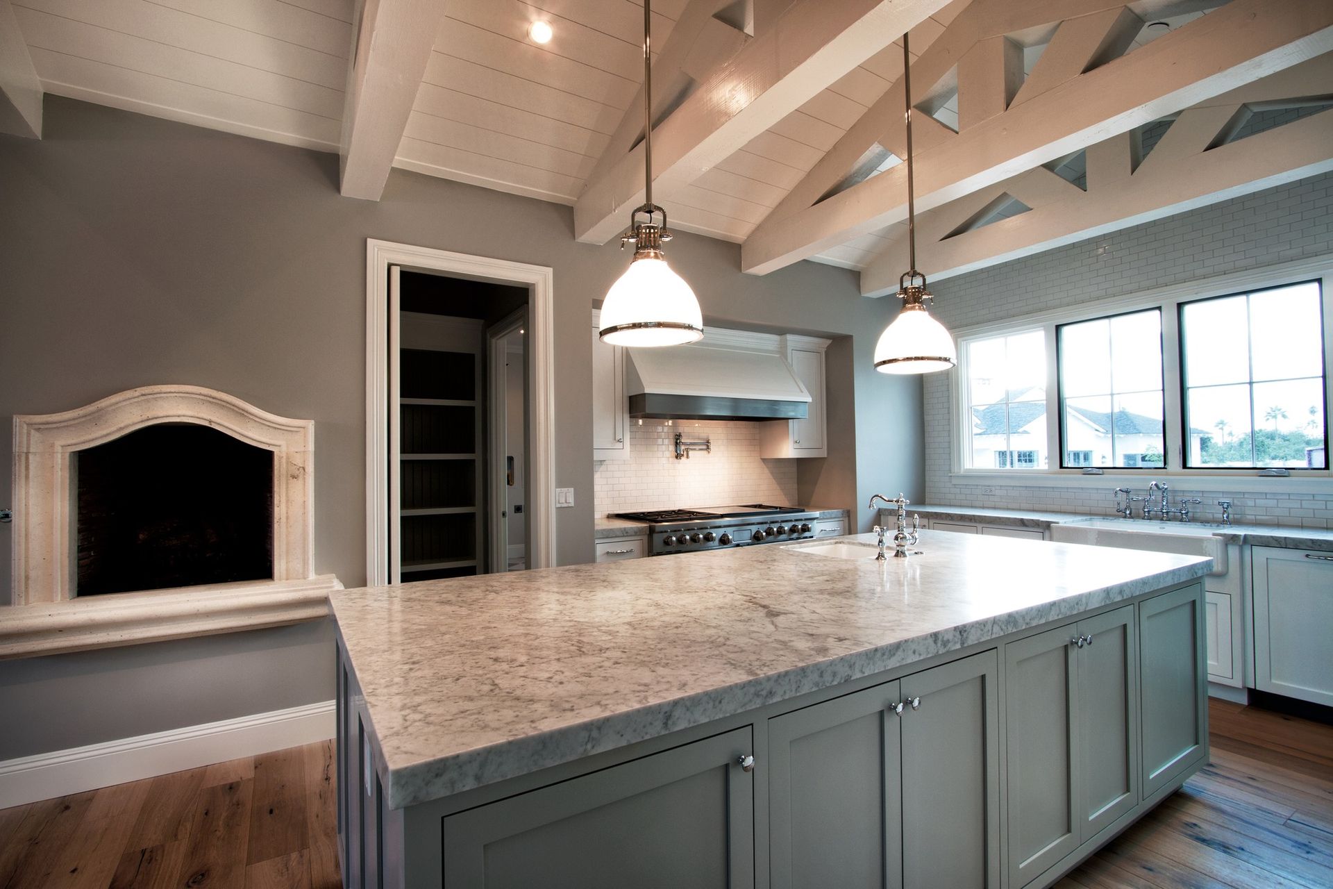 A kitchen with a large island and a fireplace