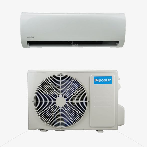 An off-white outdoor air conditioning unit with a circular fan grill mounted on a beige and brick wall.