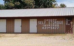 Conway Self Storage building with white doors and brown siding under a metal roof