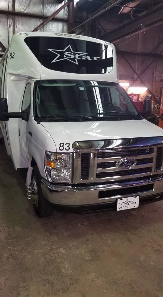 A white van with the number 83 on the front is parked in a garage.