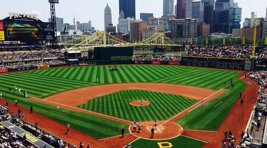 An aerial view of a baseball field with a city in the background
