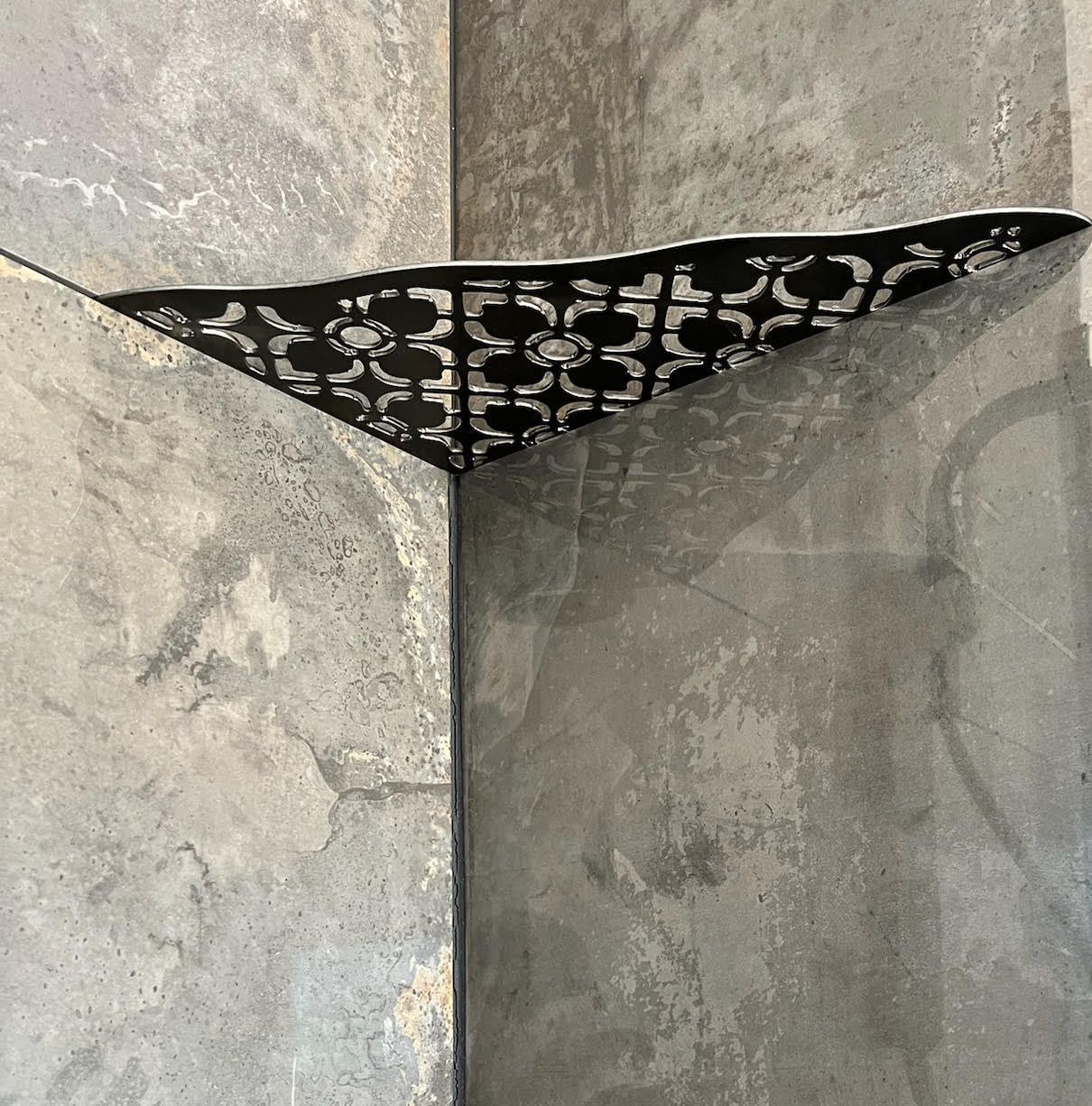A gray wall with a black triangle on it