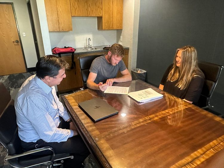 Business meeting around a glass conference table in a bright modern office