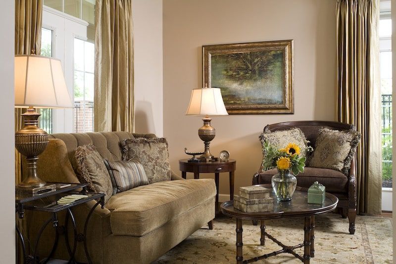 A living room with a couch a chair and a table
