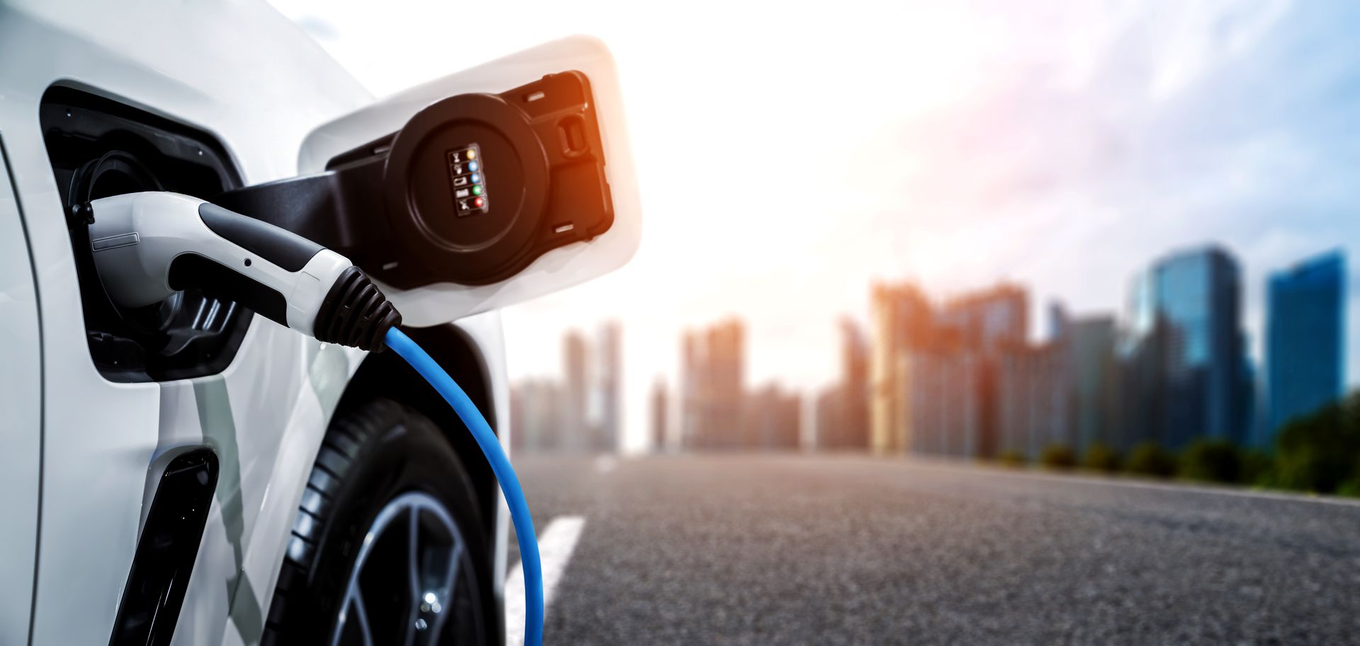 an electric car is being charged on a city street