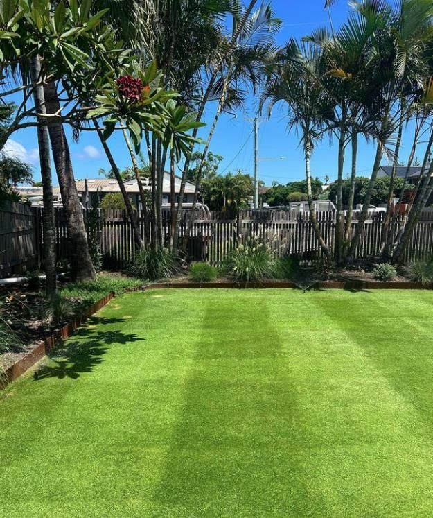 A Man Is Using A Lawn Mower To Cut The Grass In A Park — Garden Folk In Alstonville, NSW