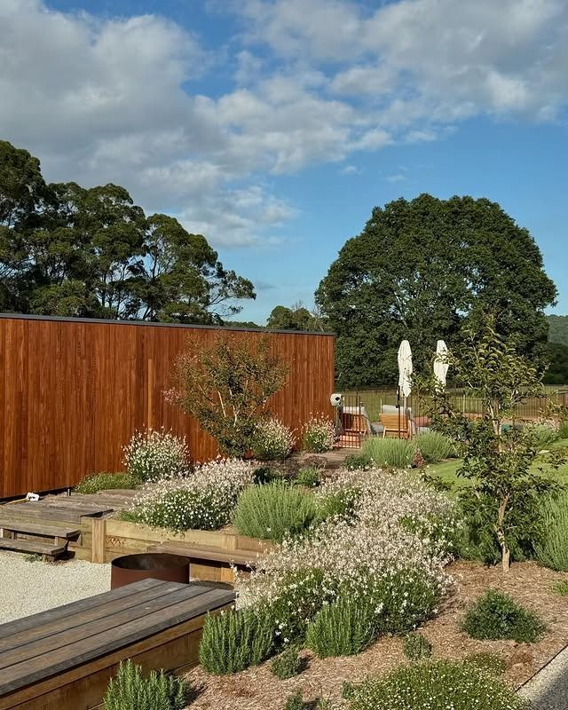 A Walkway Leading To A House With Lots Of Plants In Front Of It — Garden Folk In Ballina, NSW