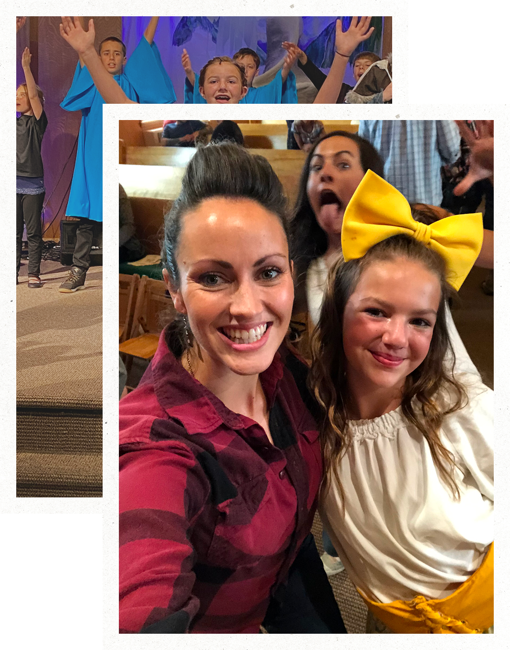 Two smiling people taking a selfie at a lively indoor event, with others cheering in the background.