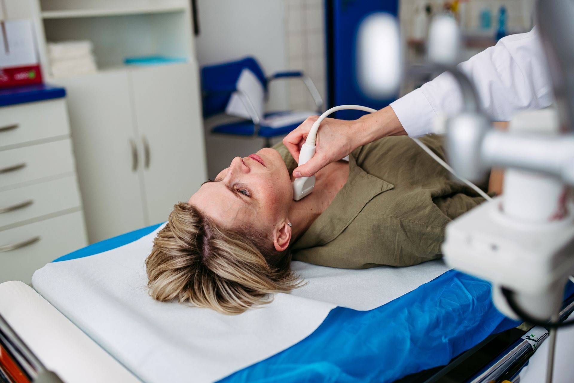 Person undergoing neck ultrasound in a medical setting
