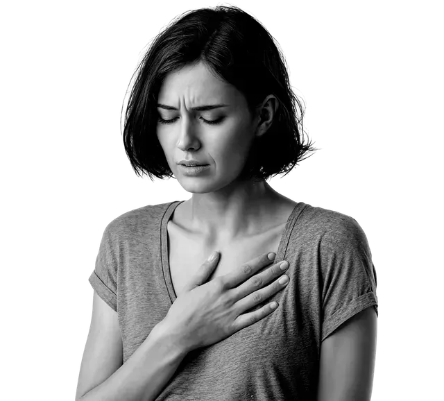 Woman with hand on chest, looking distressed with eyes closed.