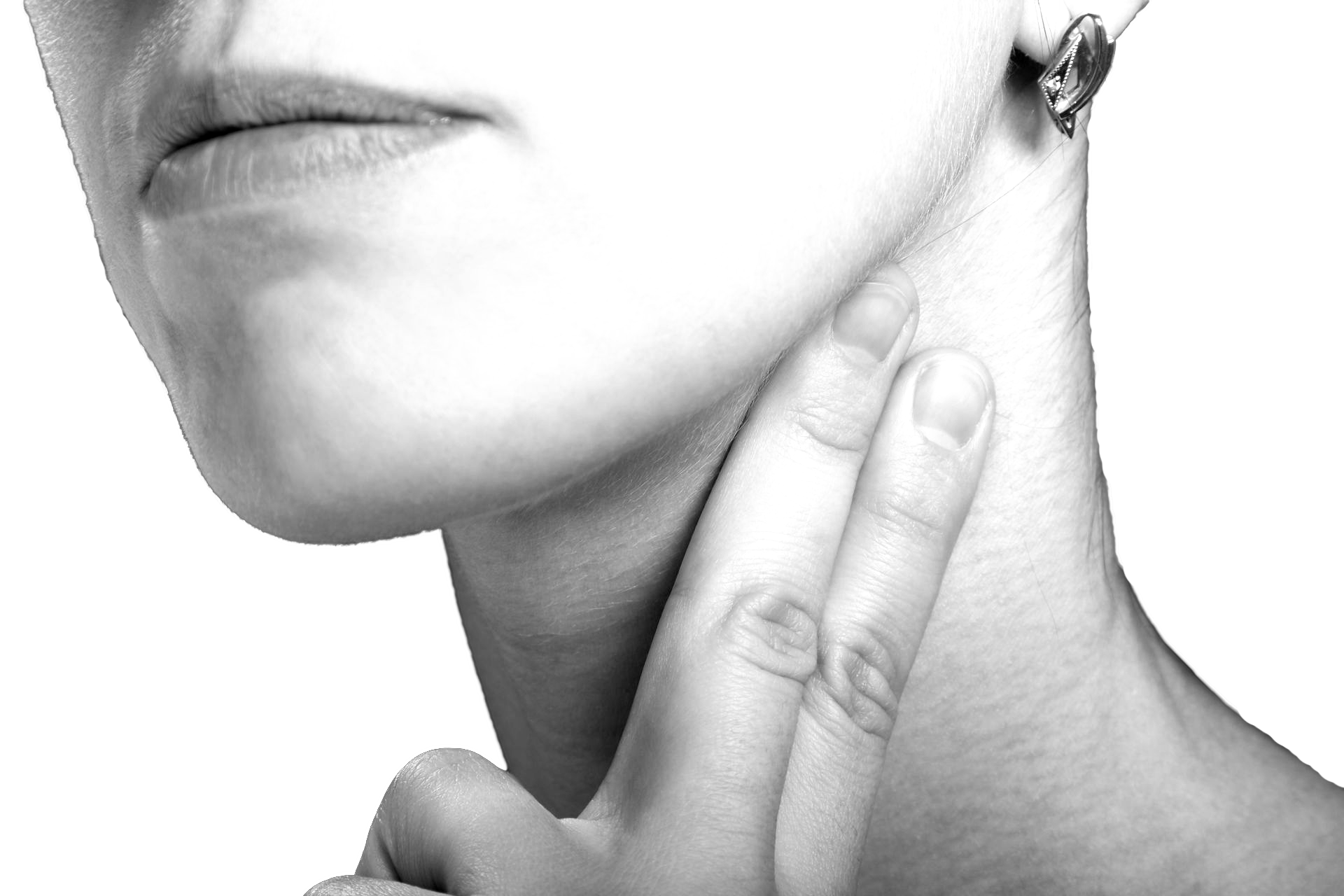 Person's fingers on neck, checking pulse. Close up in black and white.