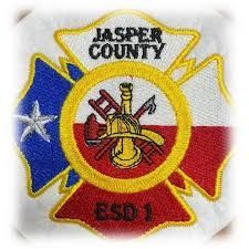 A jasper county fire department patch on a white shirt.
