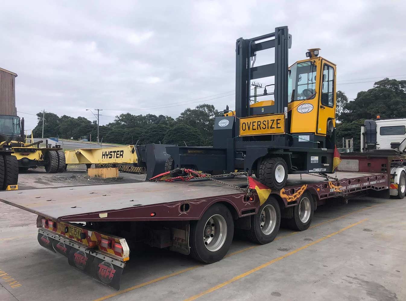 A Forklift is Sitting on Top of a Flatbed Trailer — Quick Hitch Towing & Tilt Tray Services Illawarra in Tullimbar, NSW