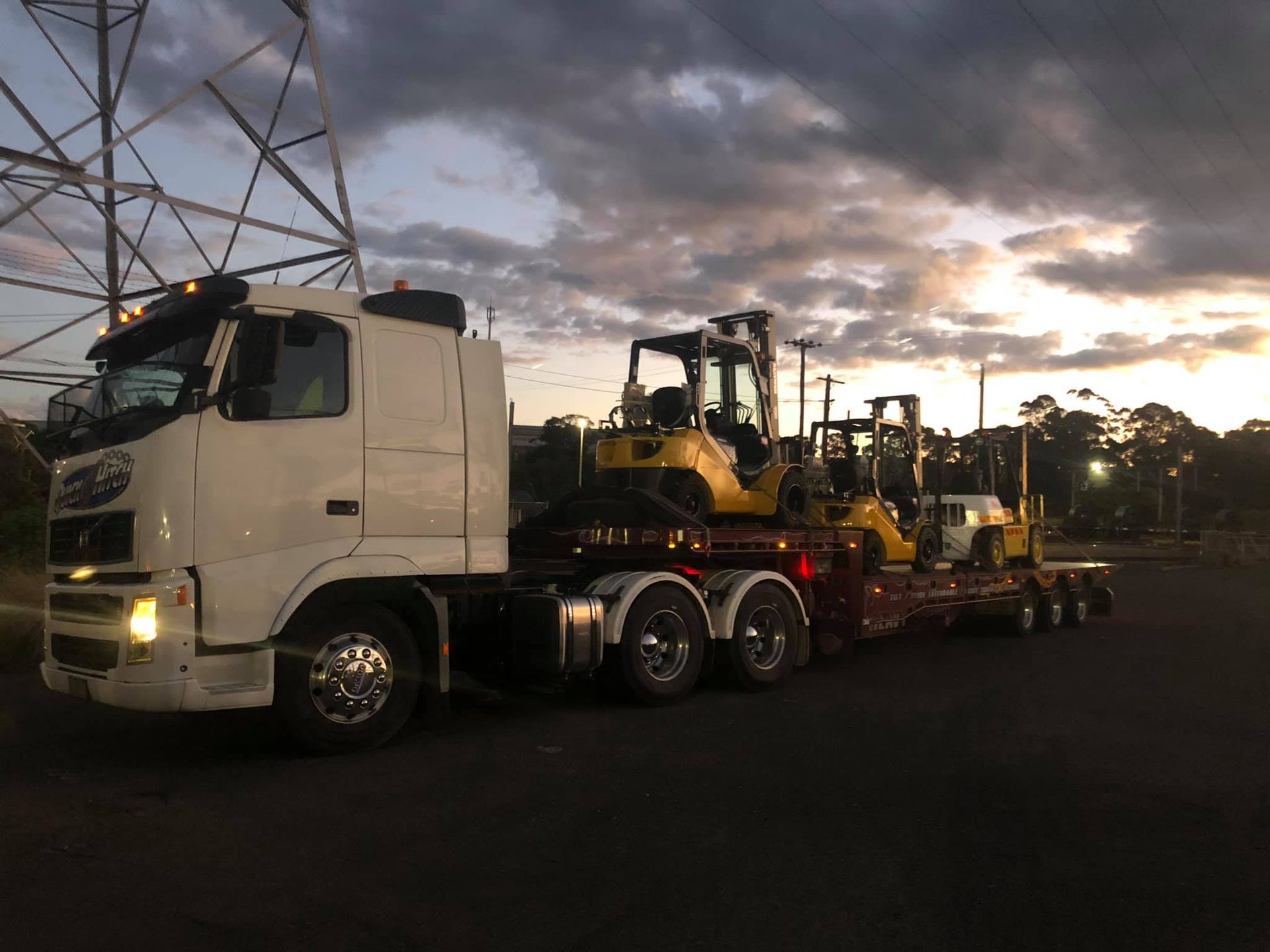 A Tow Truck is Carrying a Forklift on a Trailer — Quick Hitch Towing & Tilt Tray Services Illawarra in Shellharbour, NSW