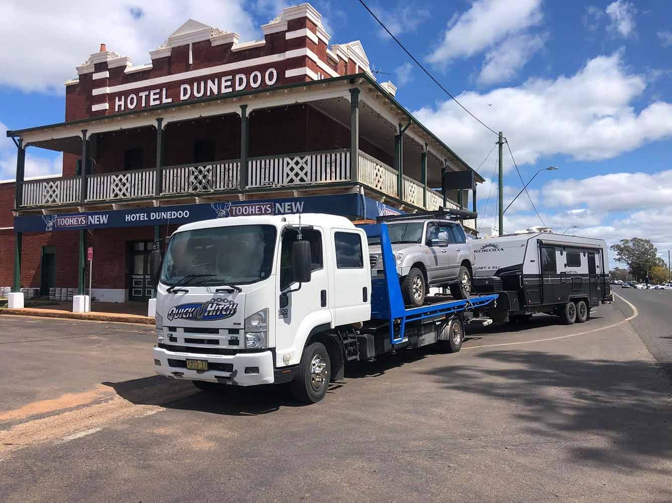 A Tow Truck is Parked in Front of a Hotel — Quick Hitch Towing & Tilt Tray Services Illawarra in Oak Flats, NSW