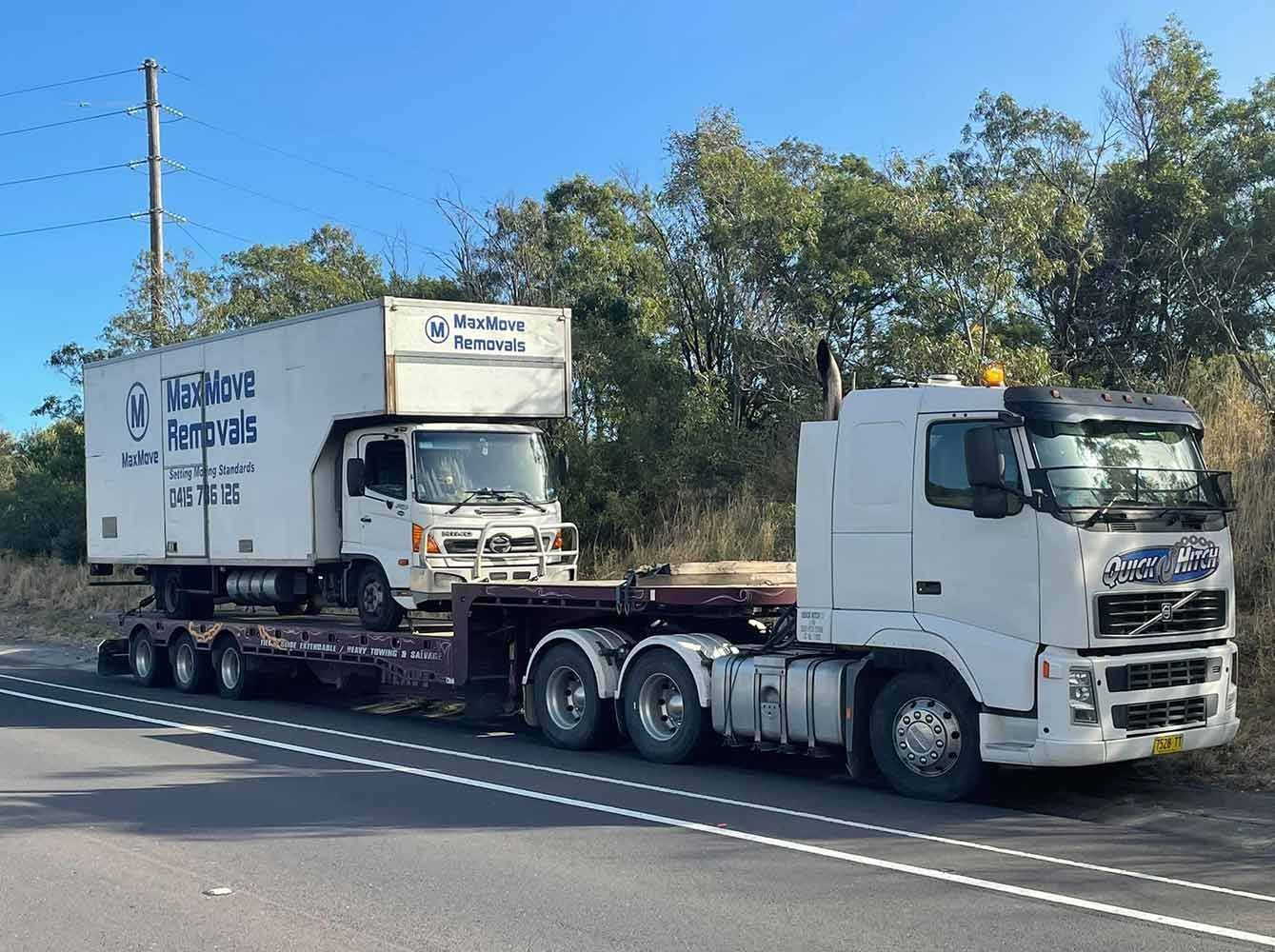 Two Trucks Are Parked on the Side of the Road — Quick Hitch Towing & Tilt Tray Services Illawarra in Oak Flats, NSW