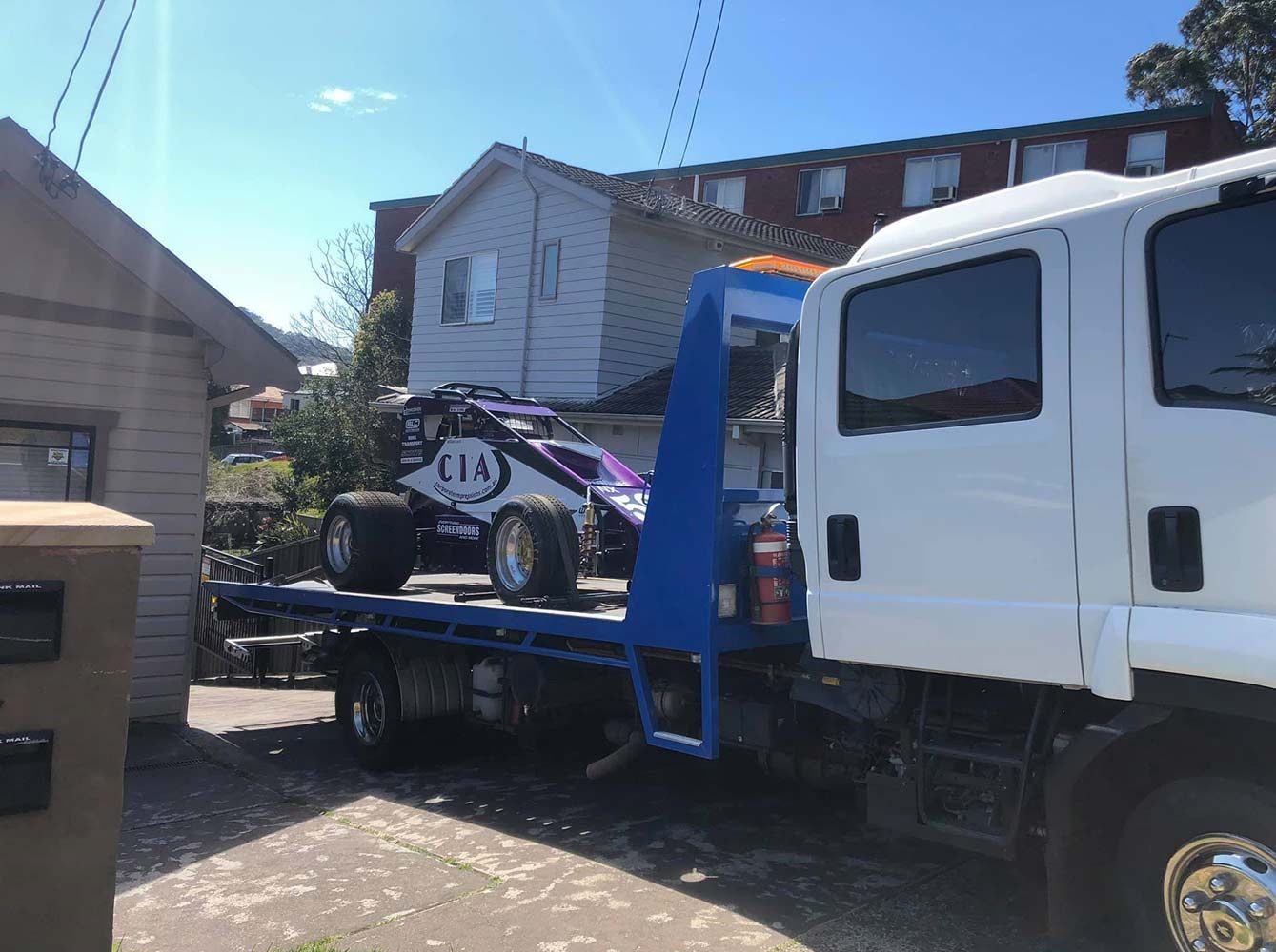 A Tow Truck is Carrying a Buggy on the Back of It — Quick Hitch Towing & Tilt Tray Services Illawarra in Helensburgh, NSW