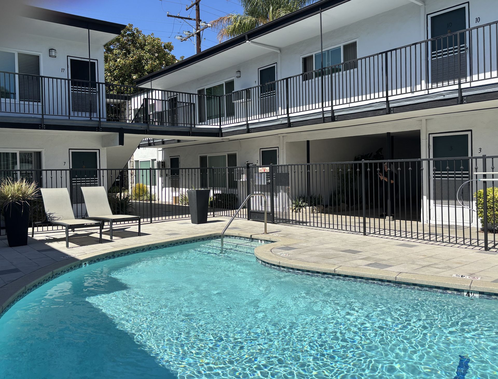 Photo of an apartment community interior, showing an open-air pool