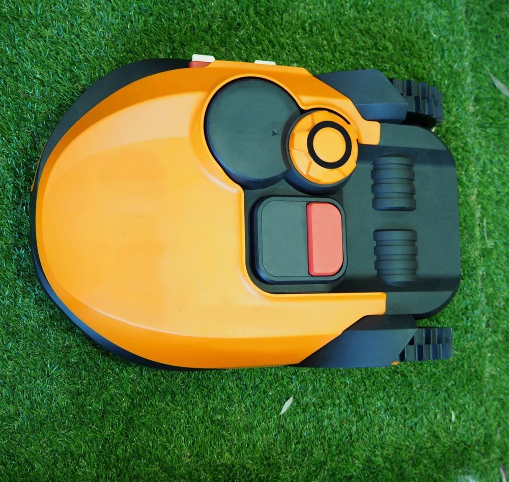 A Yellow And Black Robotic Lawn Mower Is Sitting On The Grass — Joe's Turf In Warwick, QLD