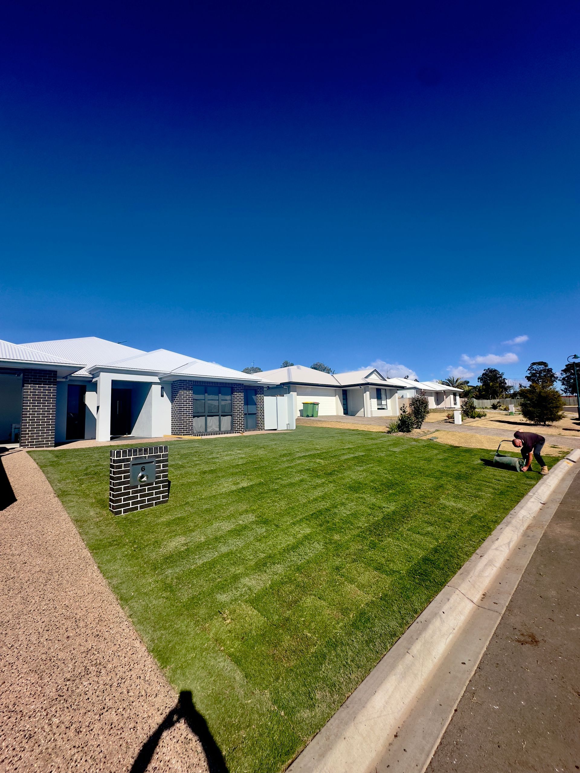 A newly laid lawn at a grey house — Joe's Turf In Spring Creek, QLD