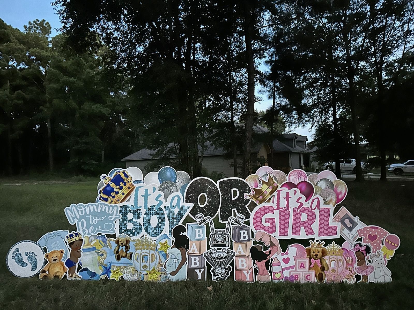 A baby shower sign that says it 's a boy or a girl