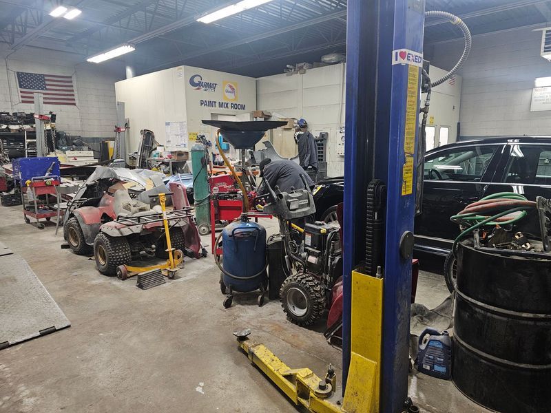 A man is working on a car in a garage.