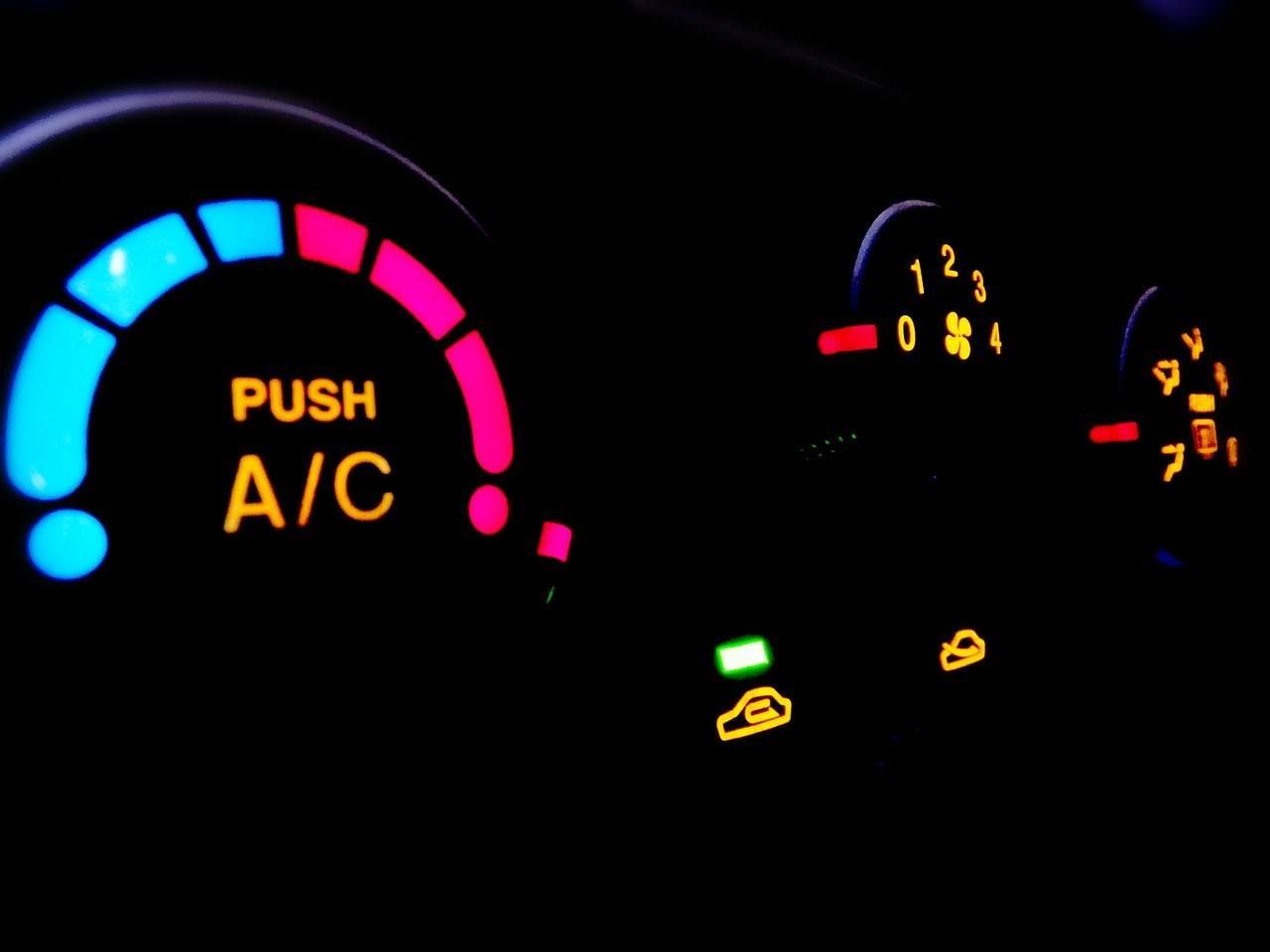 A close-up of a car dashboard that says push a/c
