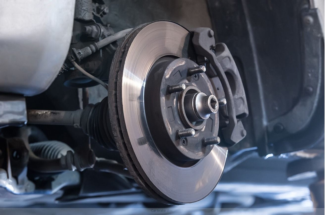 A close up of a brake disc on a car.