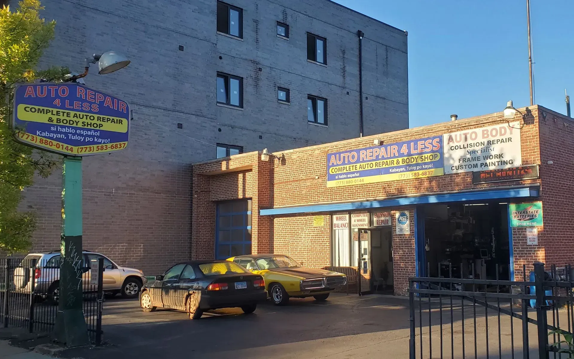 Auto Repairs 4 Less building with cars parked in front of it.