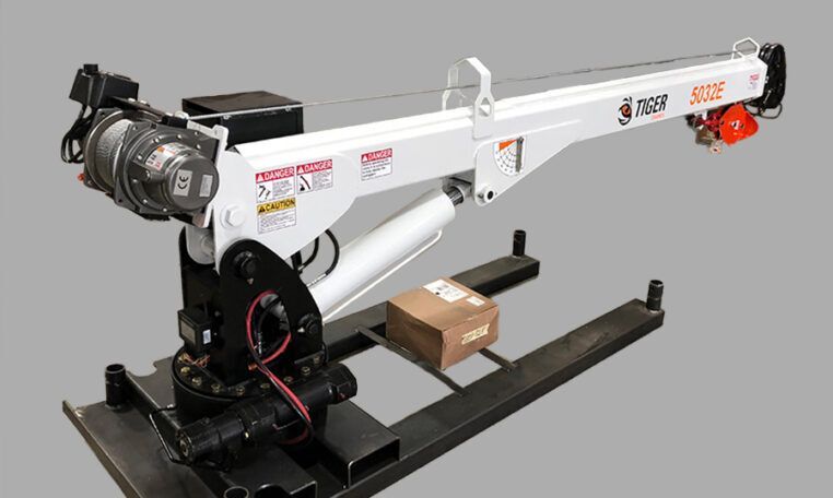 White hydraulic crane with a box, mounted on a black metal base.
