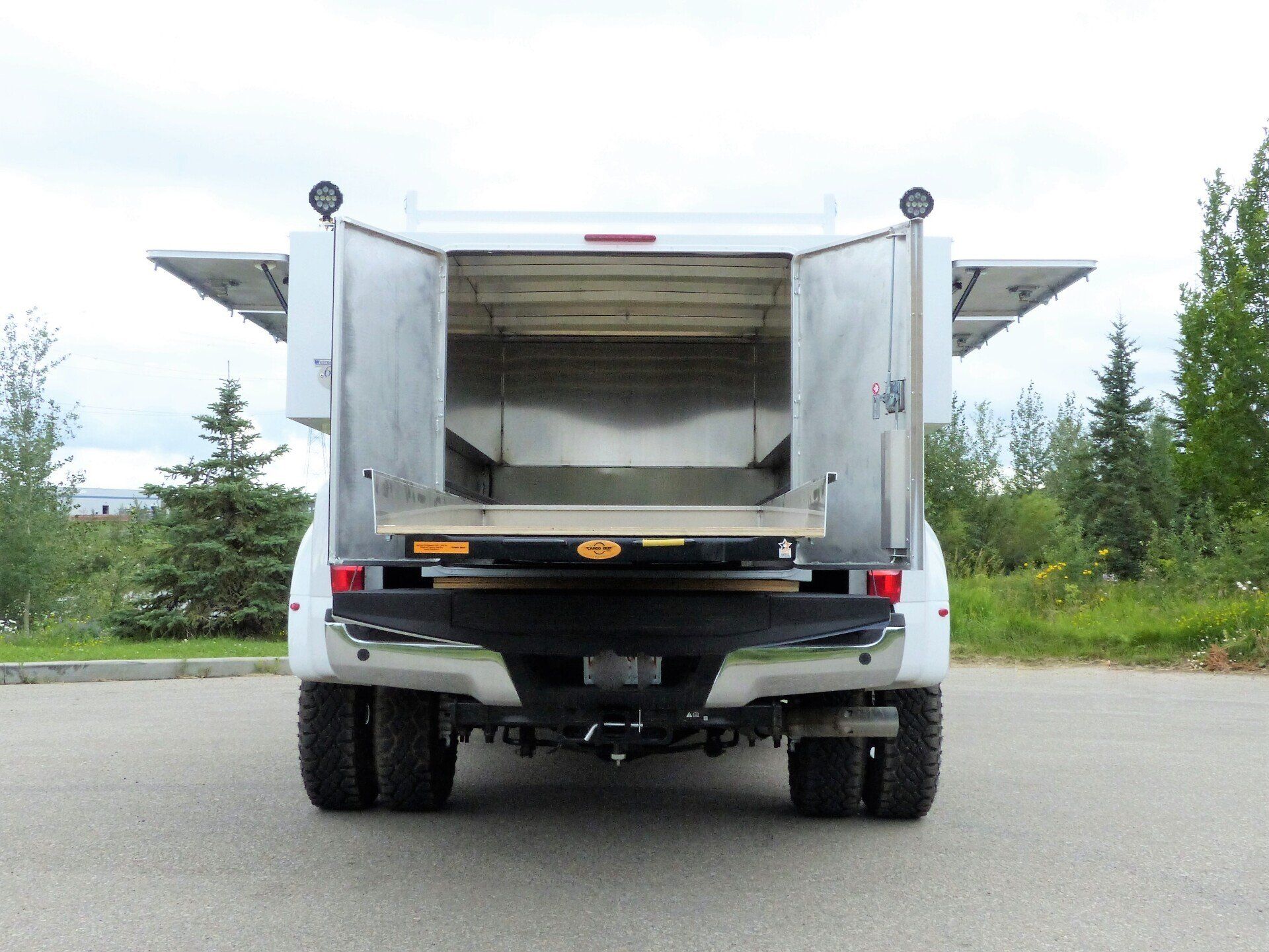 The back of a white truck with the doors open