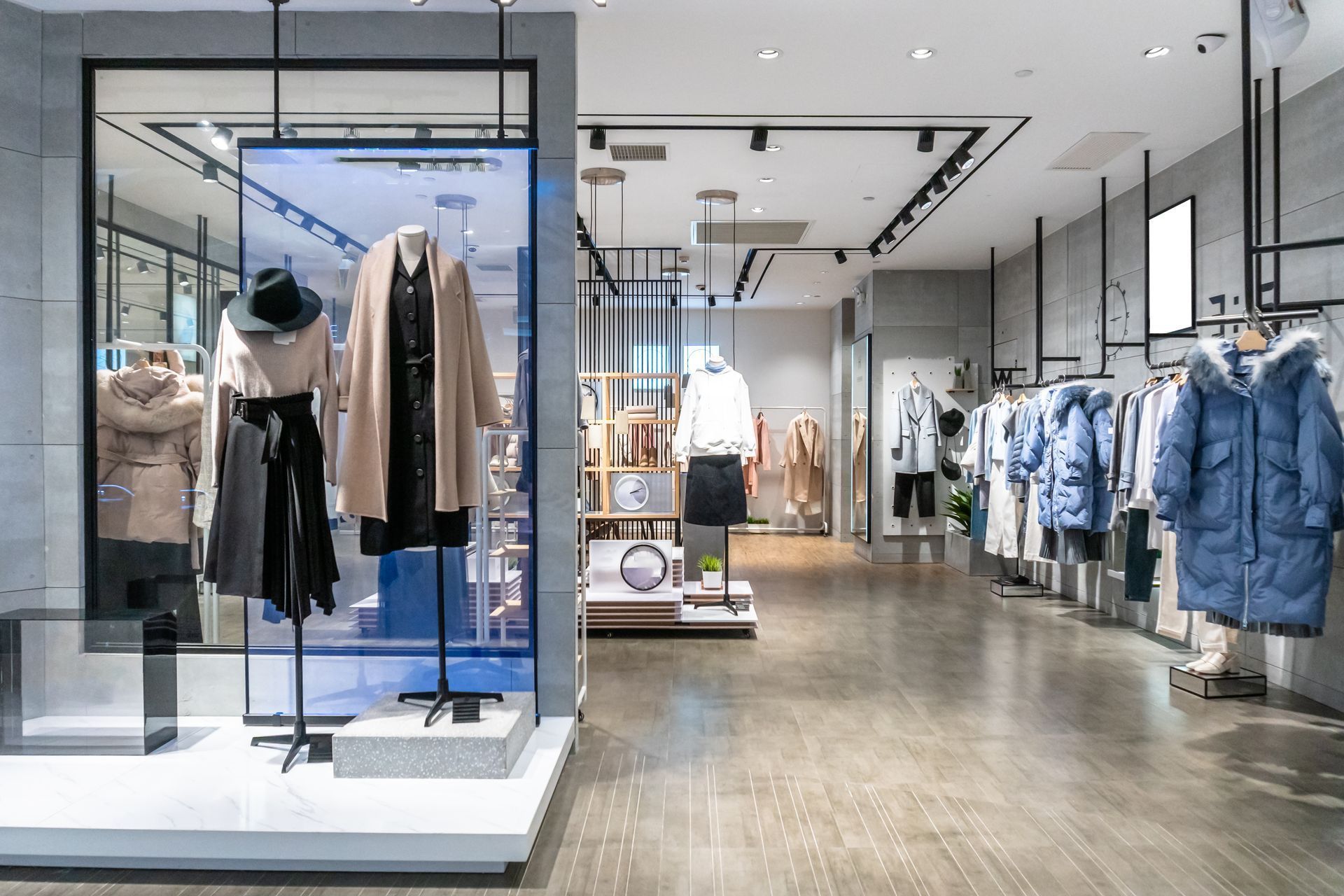 Modern clothing store interior with racks of jackets and coats on display