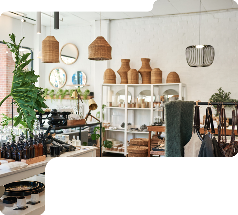 Bright boho-style home decor shop with woven baskets, shelves, and hanging lamps