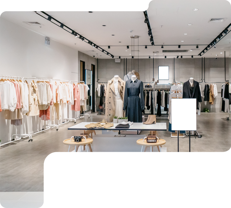 Minimalist clothing boutique interior with racks of neutral-toned garments and display tables