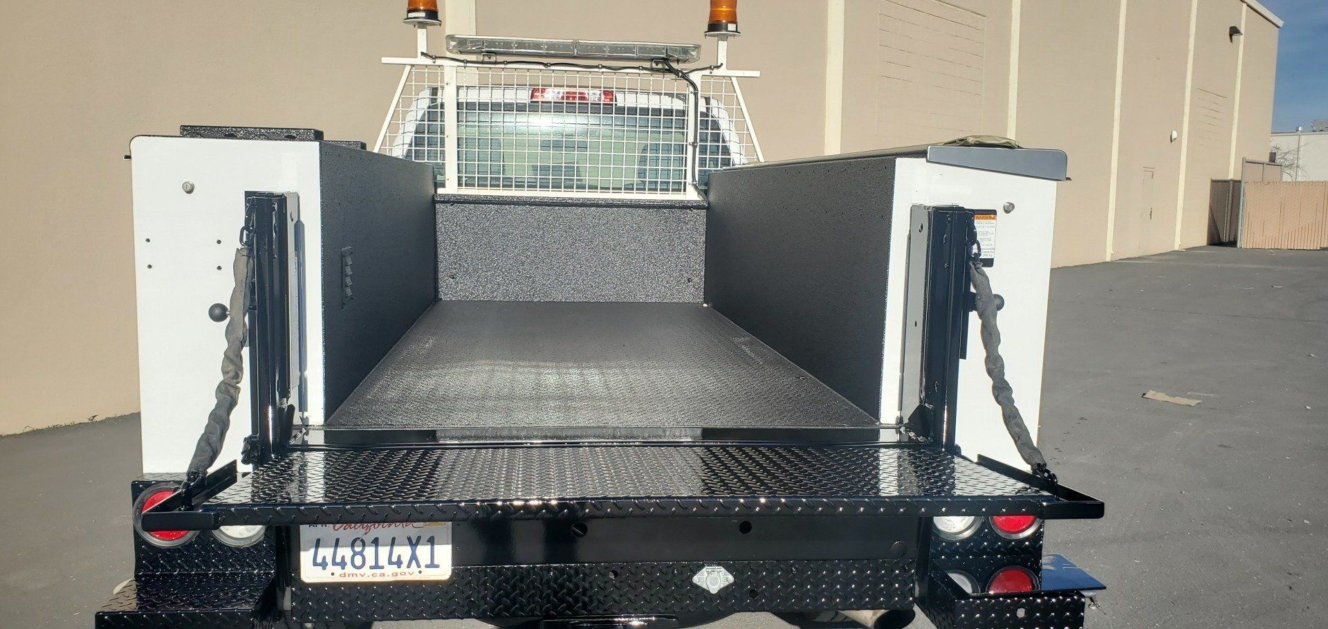 The back of a truck with a license plate that says lx57l01