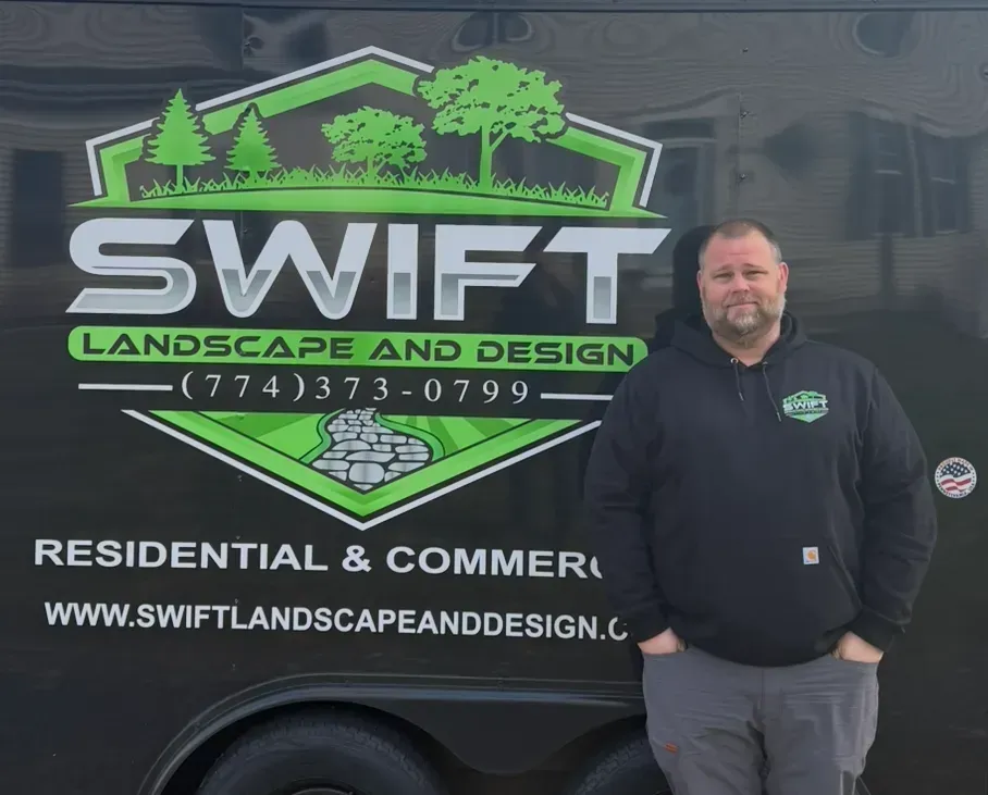 Swift Landscape and Design truck wrap with company logo and a man standing beside it