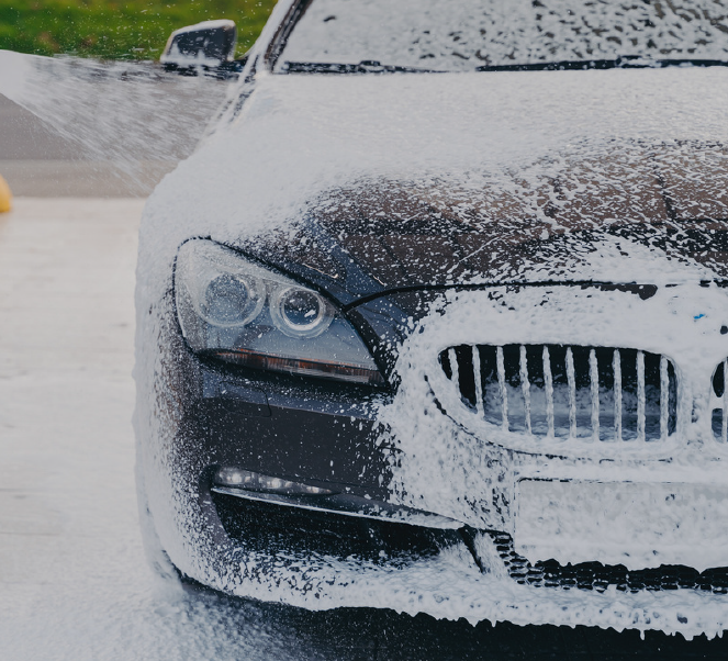 A bmw car is covered in foam and soap