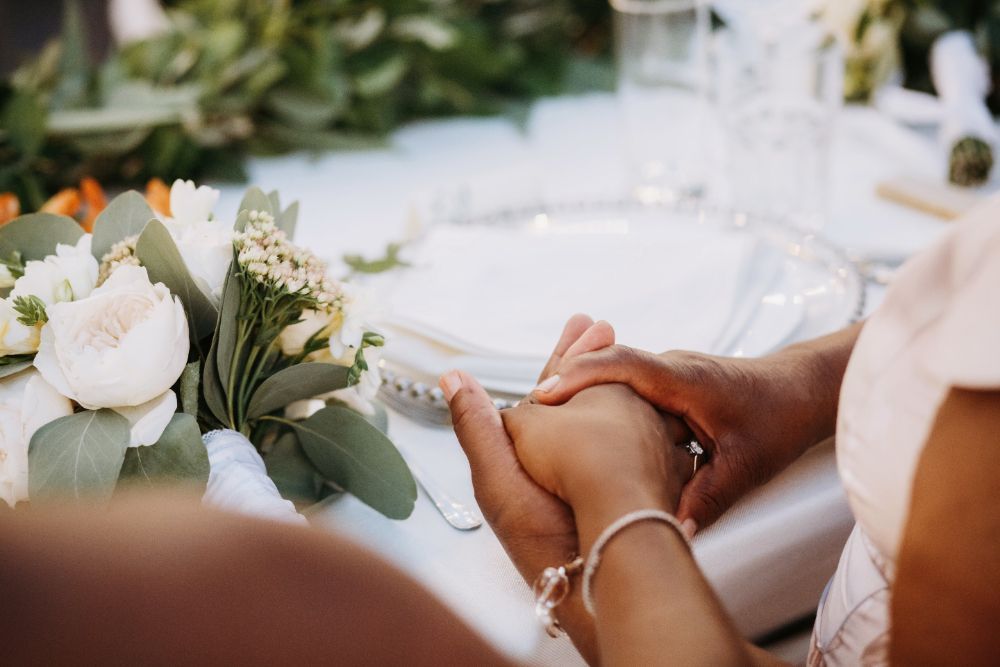 Uma noiva e um noivo estão de mãos dadas na recepção do casamento.-Pousada-Recanto-do-Chef