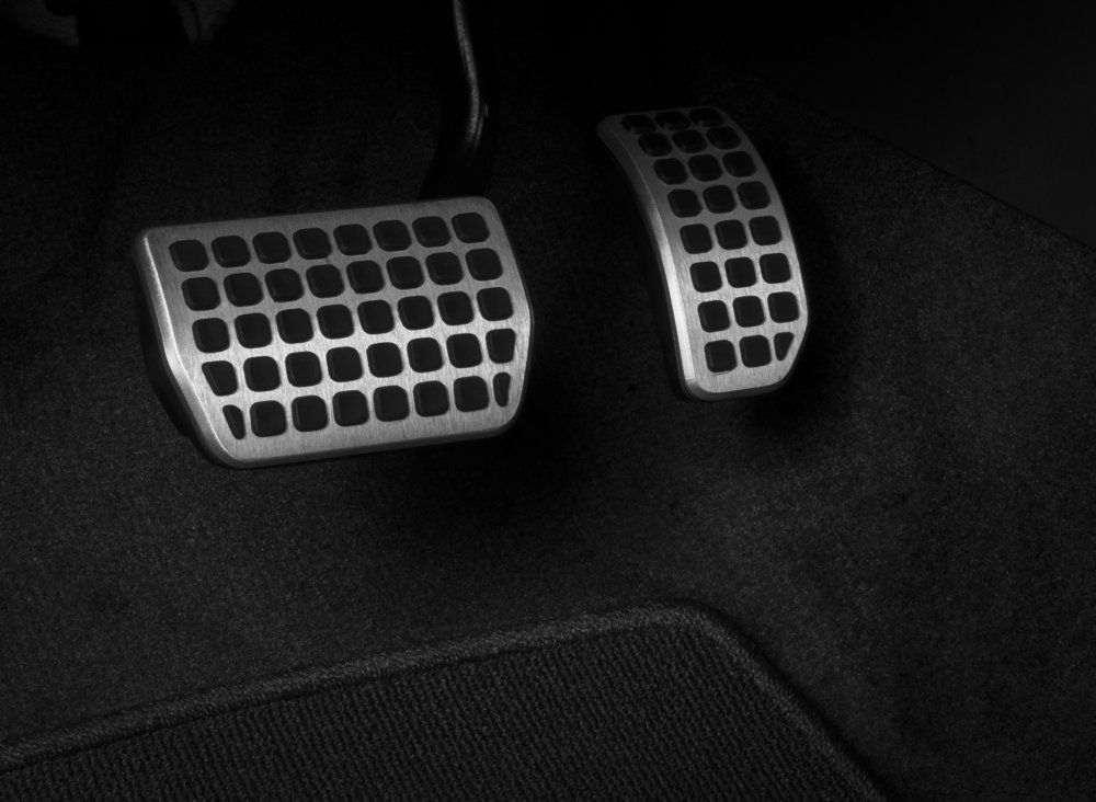Metal Car Pedals Against Dark Fabric — Motorhead Garage in Tweed Heads, QLD