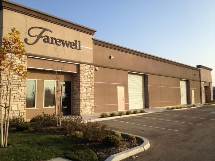 Exterior of Farewell funeral home building with tan stone facade and empty parking lot
