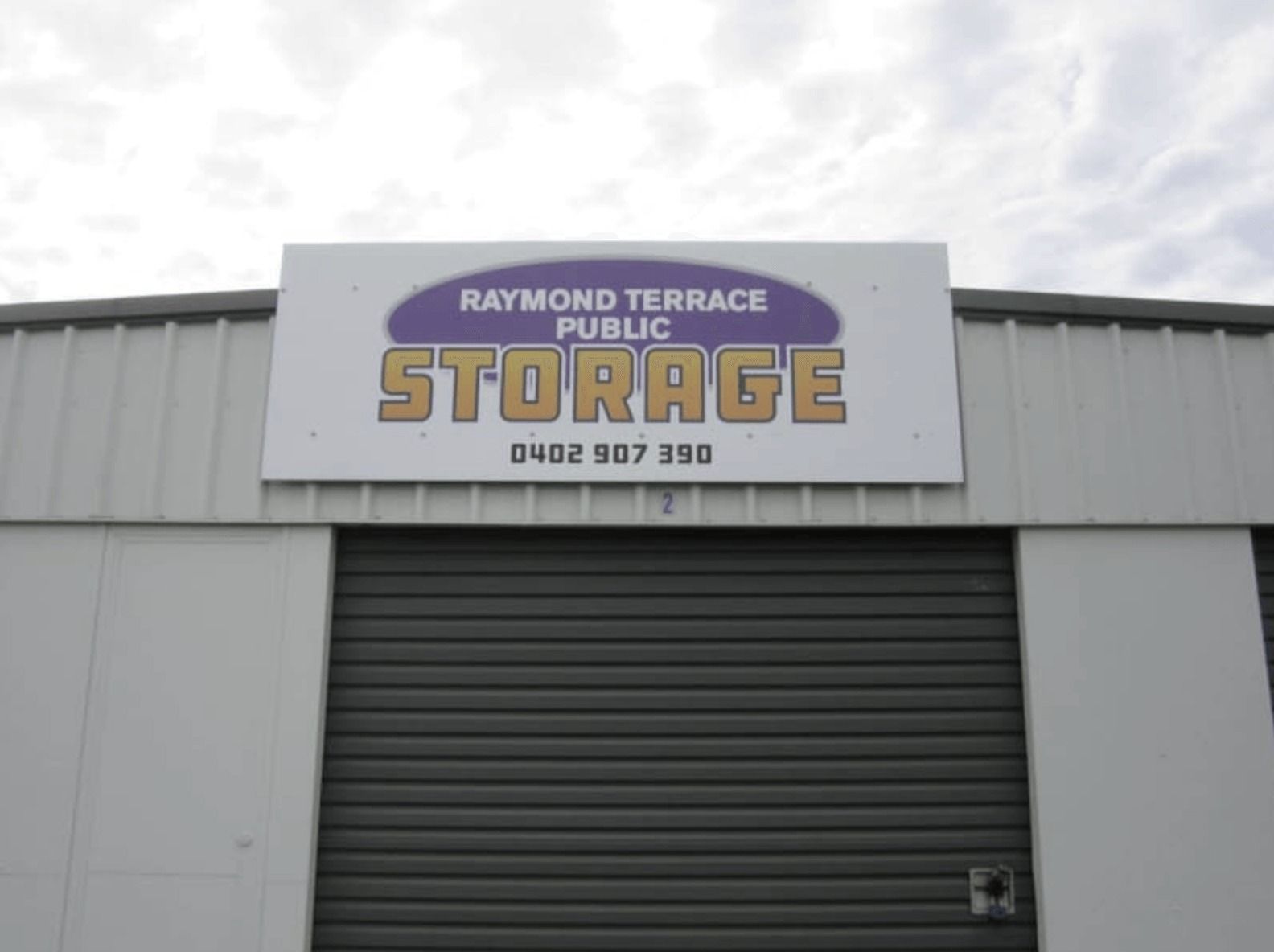 A Building With A Sign That Says Raymond Terrace Public Storage — Raymond Terrace Public Storage In Heatherbrae, NSW
