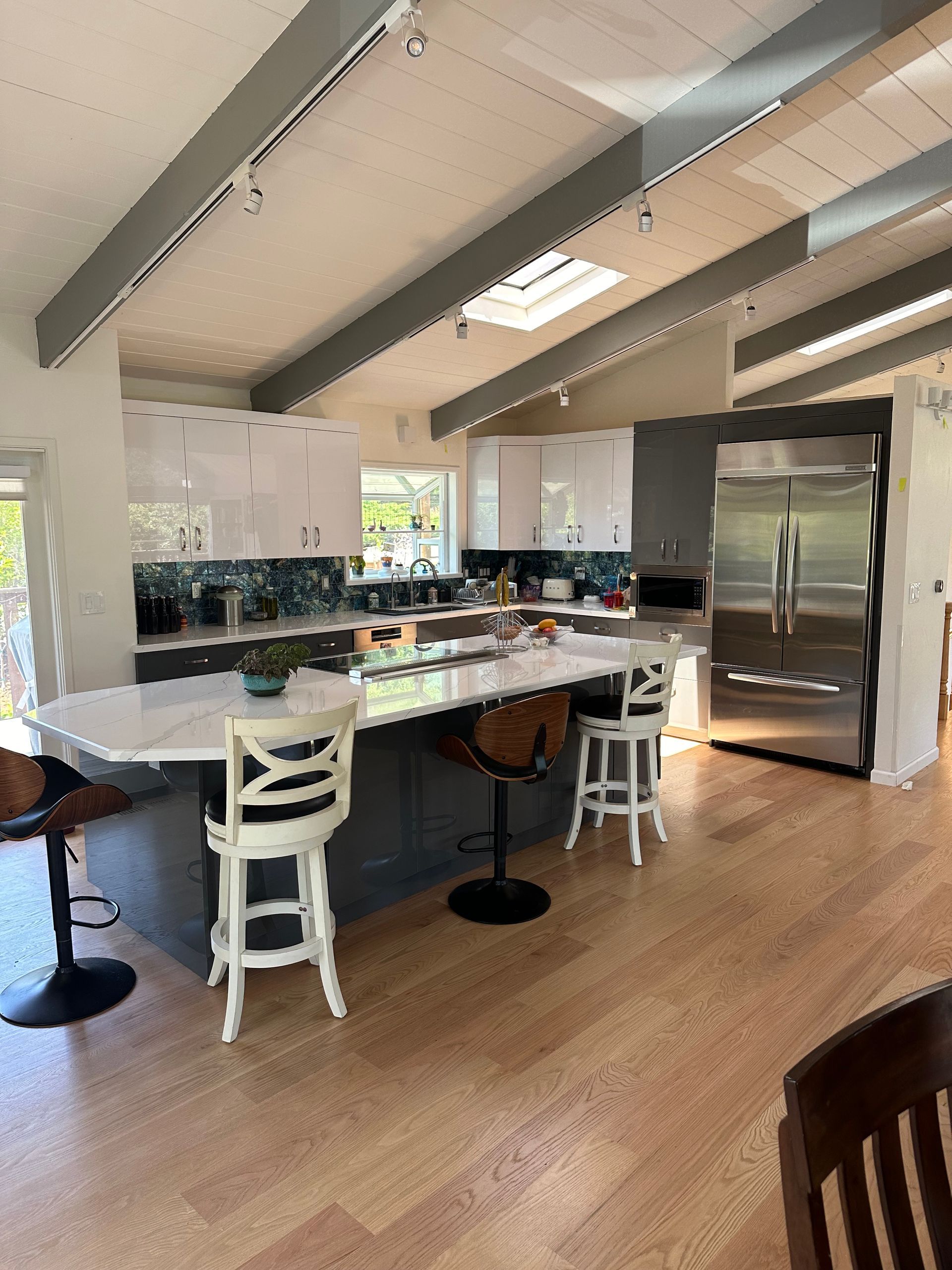 A kitchen with a table and chairs and a refrigerator.