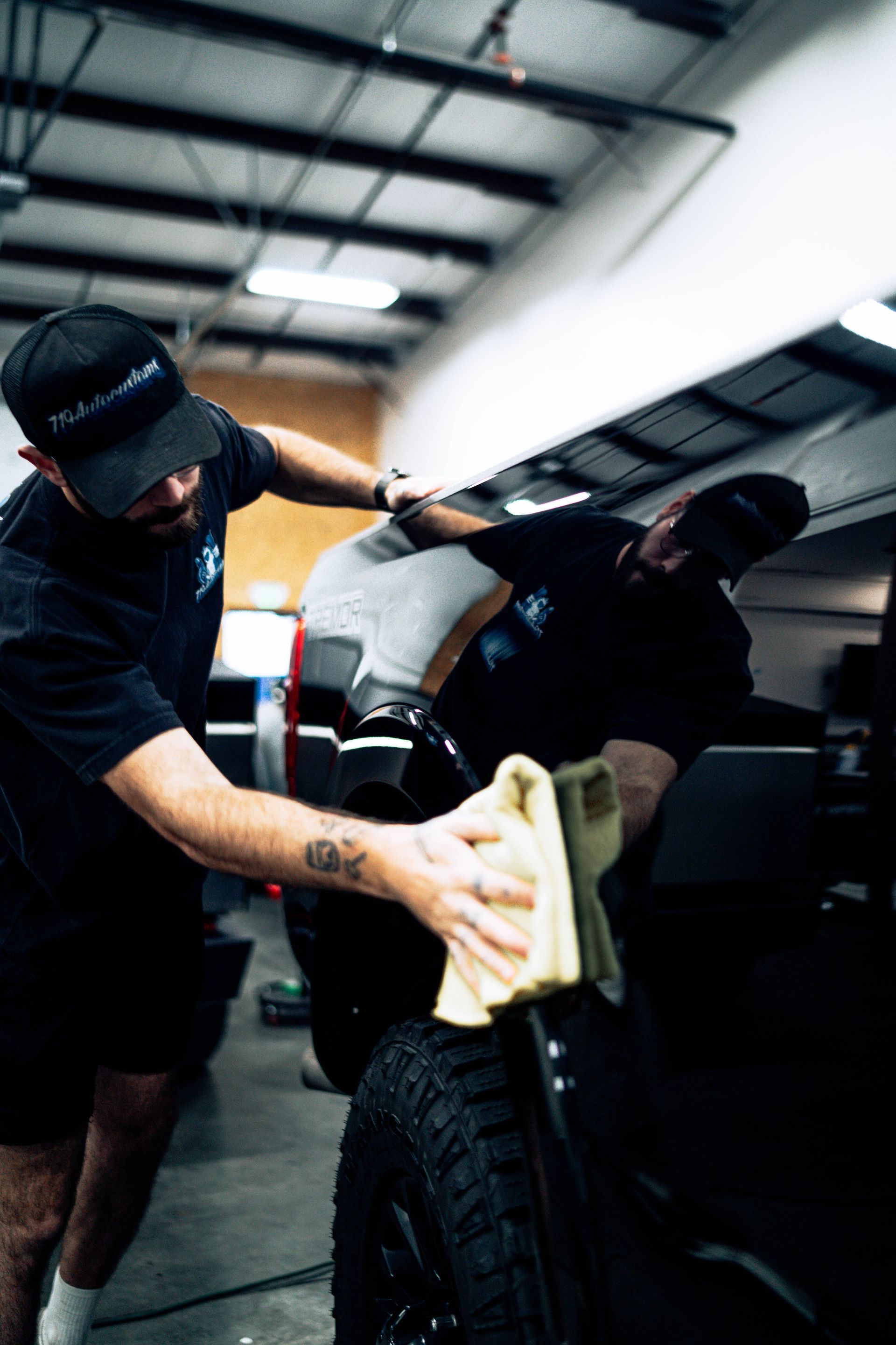 719 Auto Customs technicians applying ceramic coating in the shop