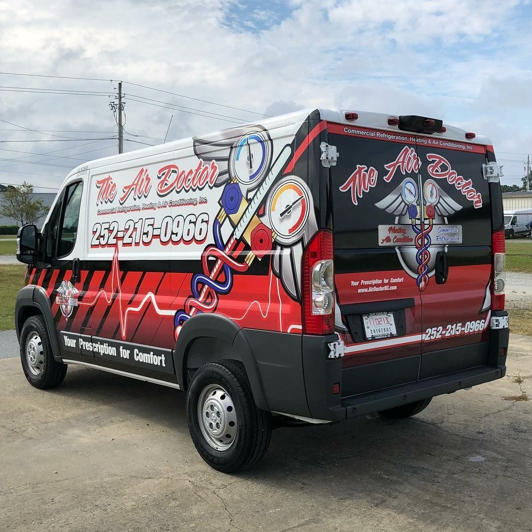 A white and black service van featuring a red heartbeat line, HVAC gauge graphics, and
