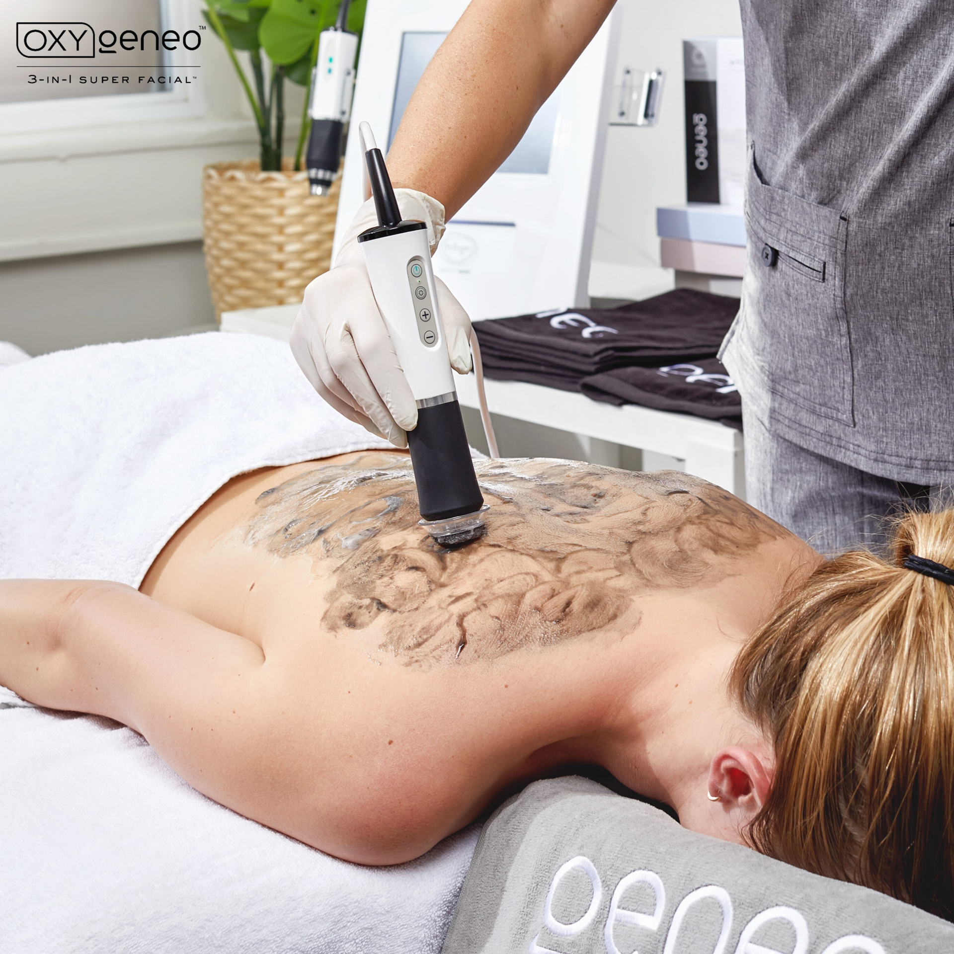 Person receiving a back massage with a handheld device on a spa treatment table