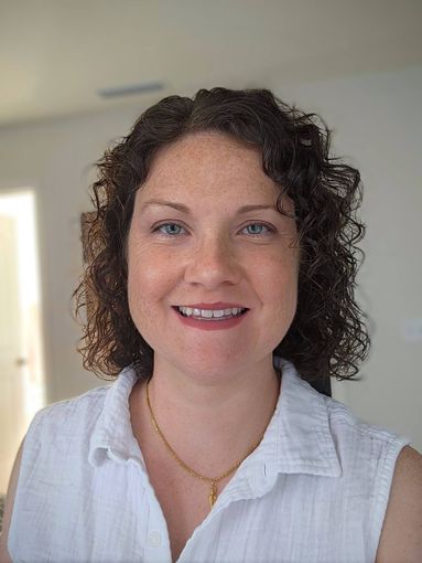 Picture of Carolyn a lady with curly brown hair and a big smile