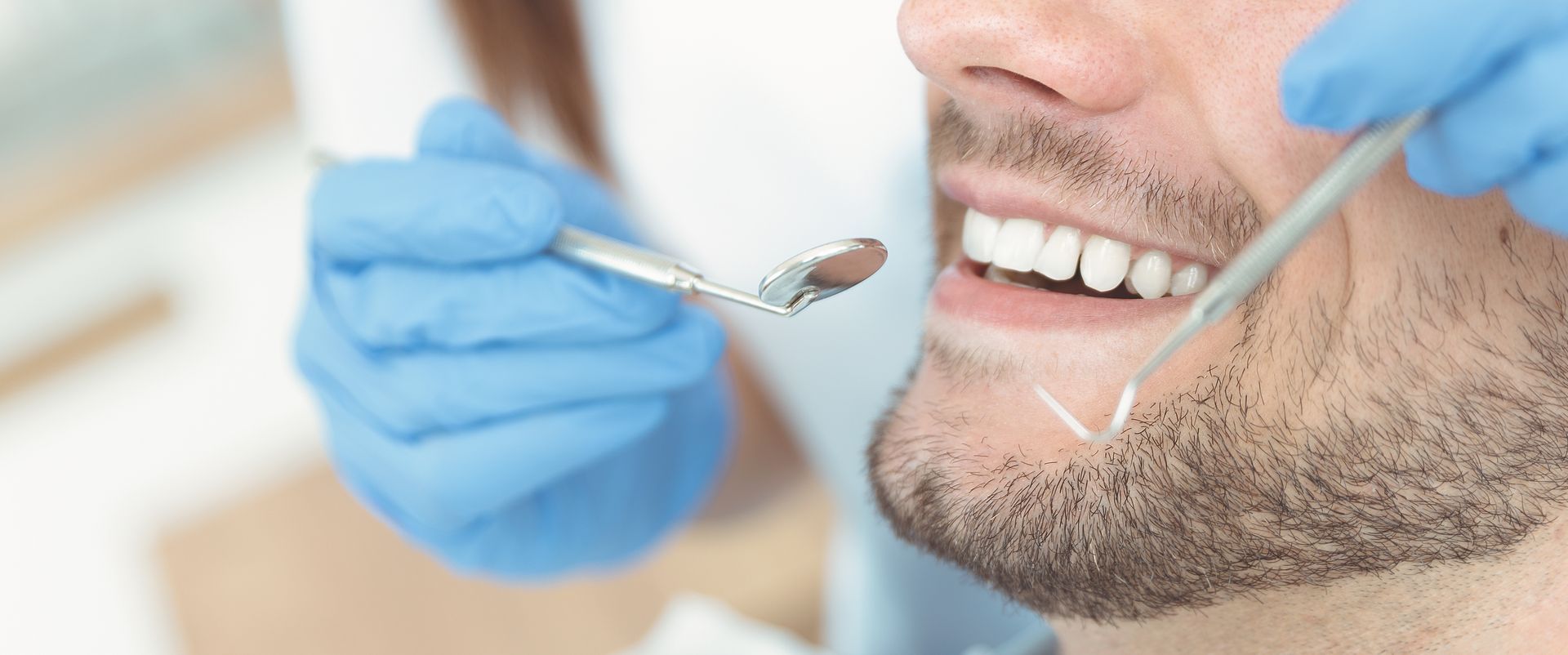 Professional Dentist — Mansfield, OH — Mark A. Massa, DDS, Inc. Close-up of a patient receiving a General Dentistry checkup with a dental mirror