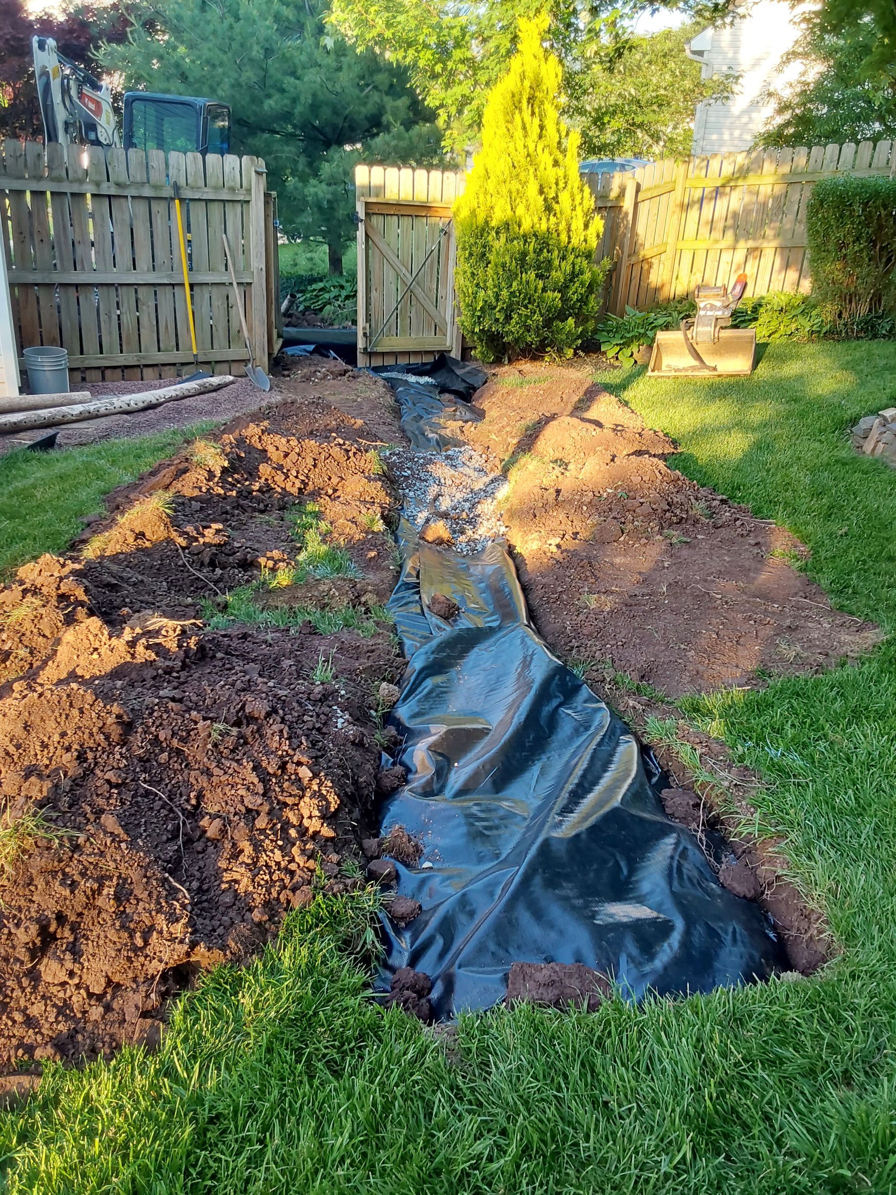 a drainage system is being installed in a backyard