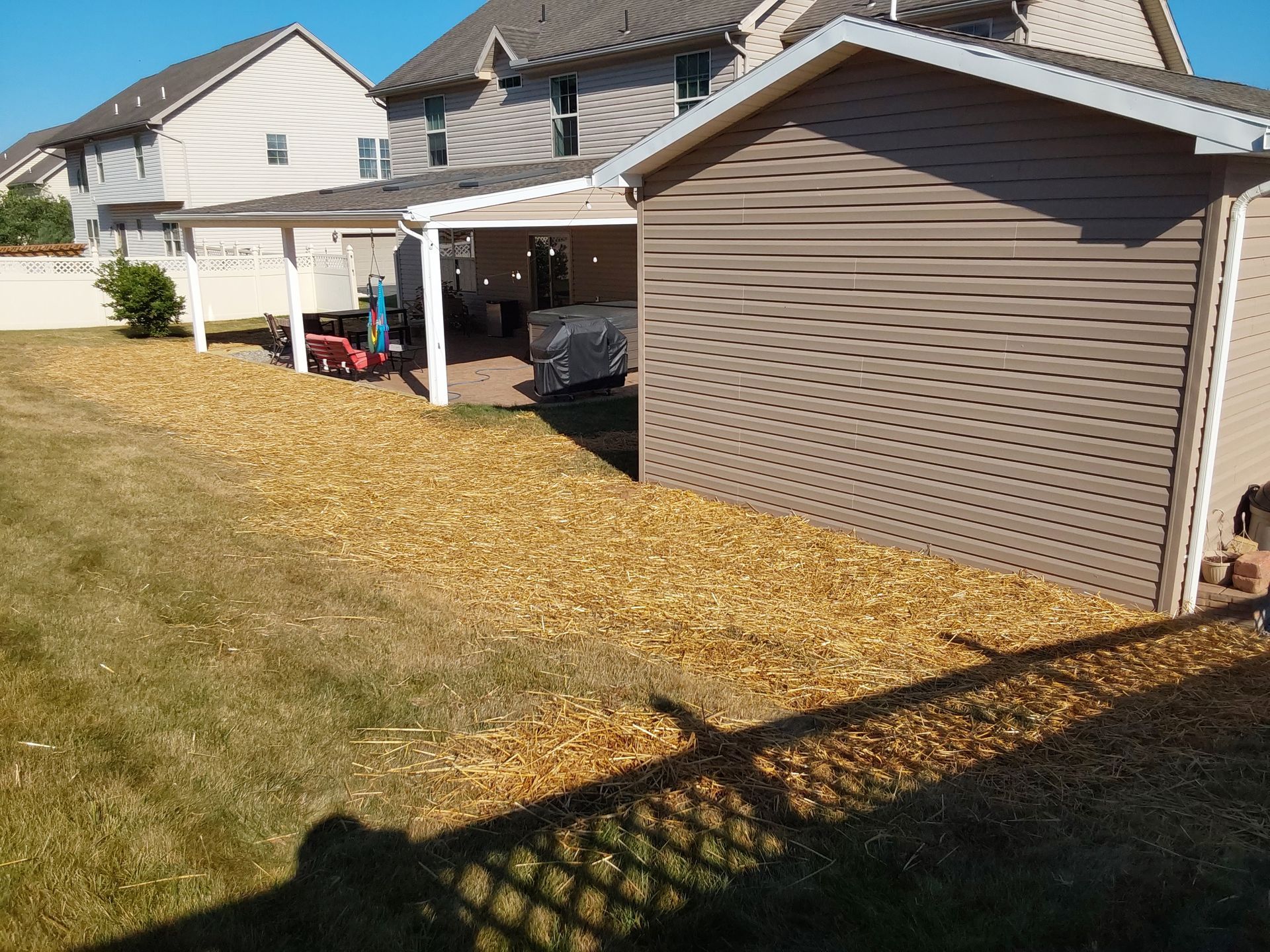 a house with a garage and a shed in the backyard